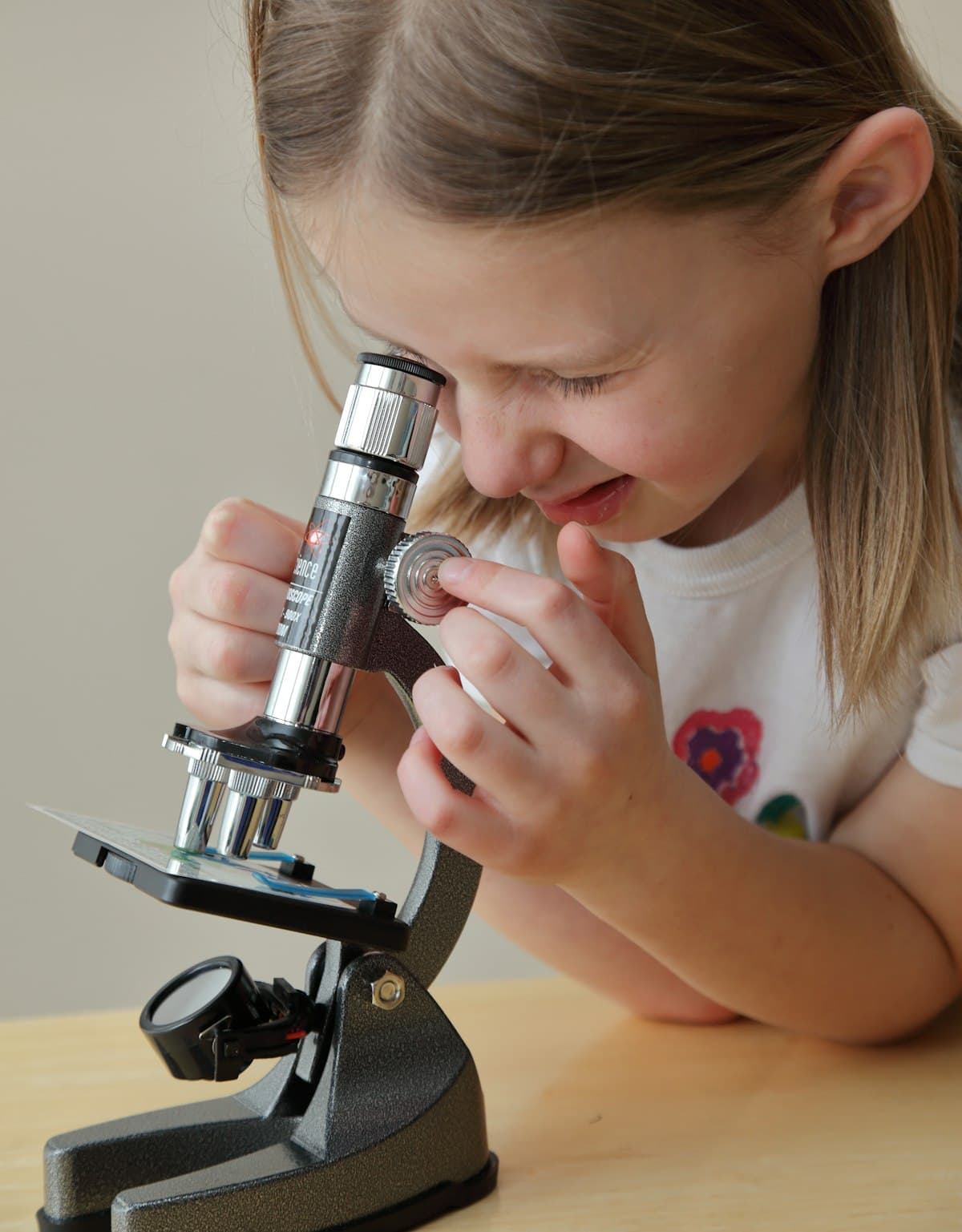 A girl looking through a microscope
