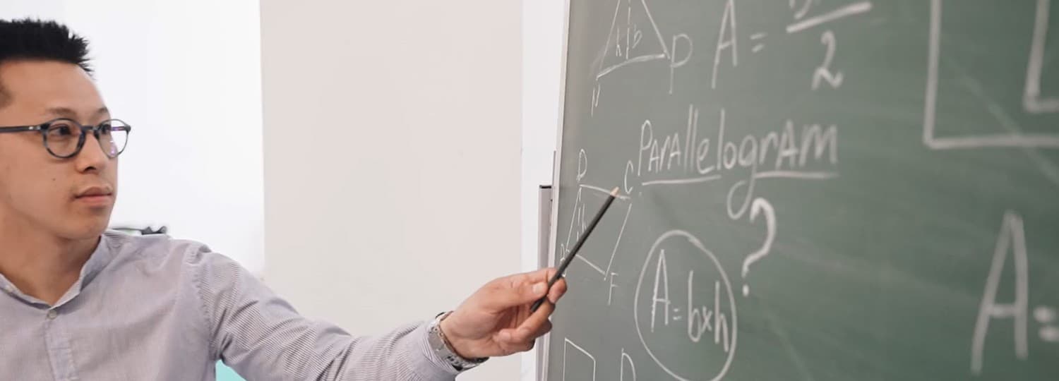 A teacher explaining a concept at the board